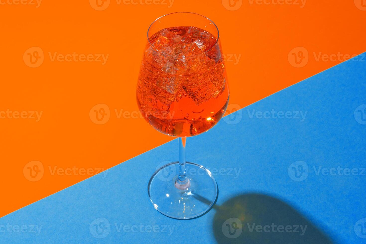 Glass of fresh cocktail on color background photo