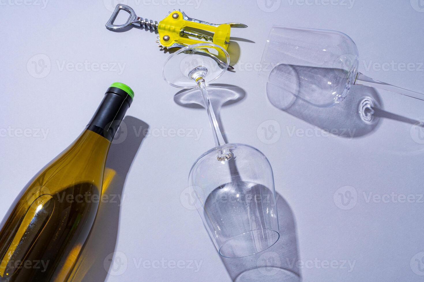 Wine bottle and glass on gray background flat lay photo