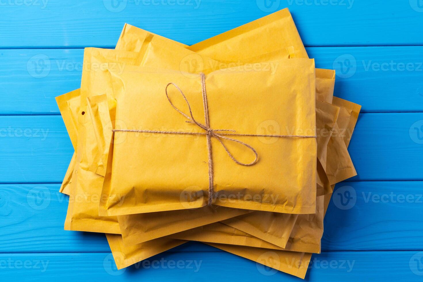 Lot of yellow paper postal envelopes. Top view. photo