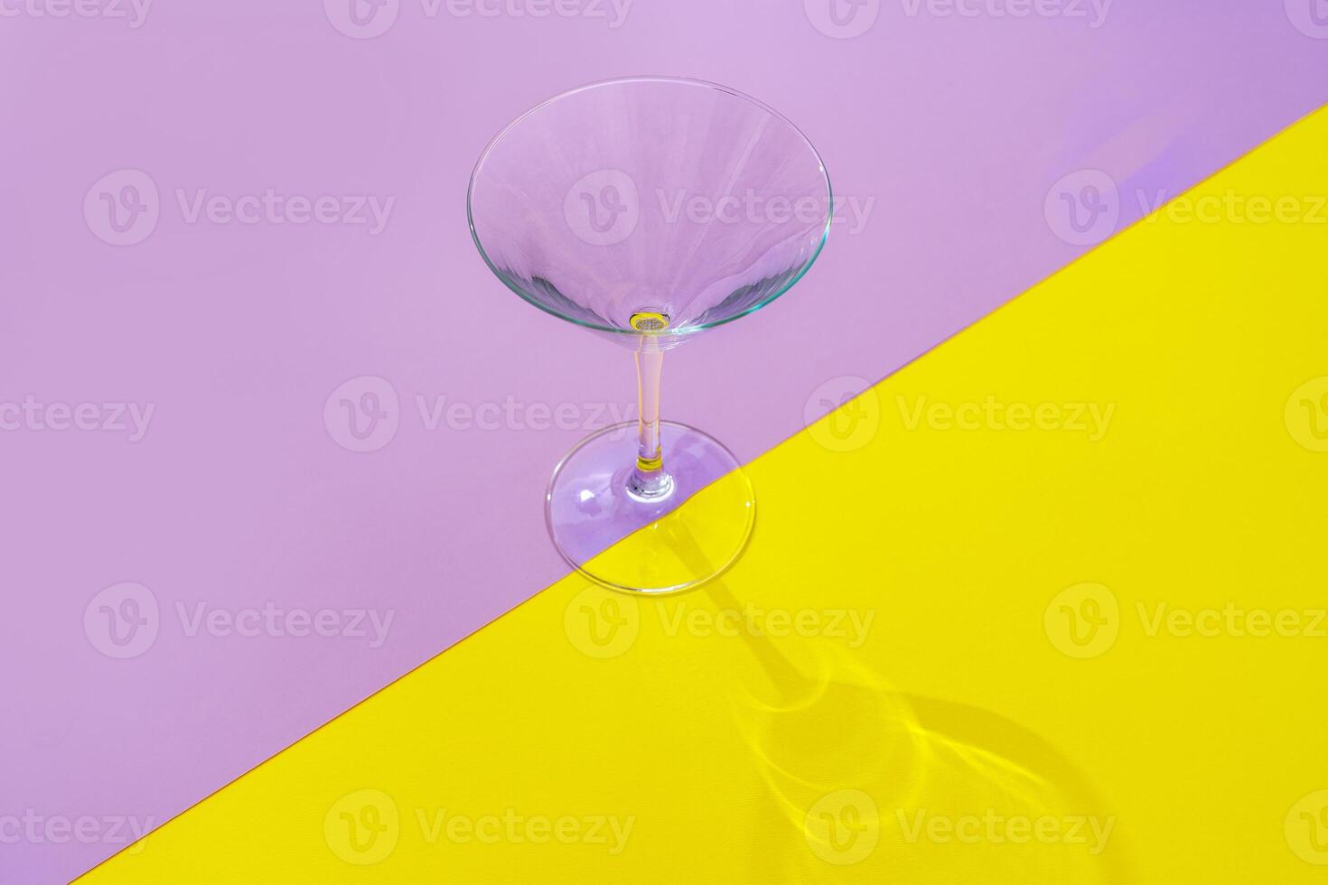 Empty transparent glass on a color background with copyspace. photo