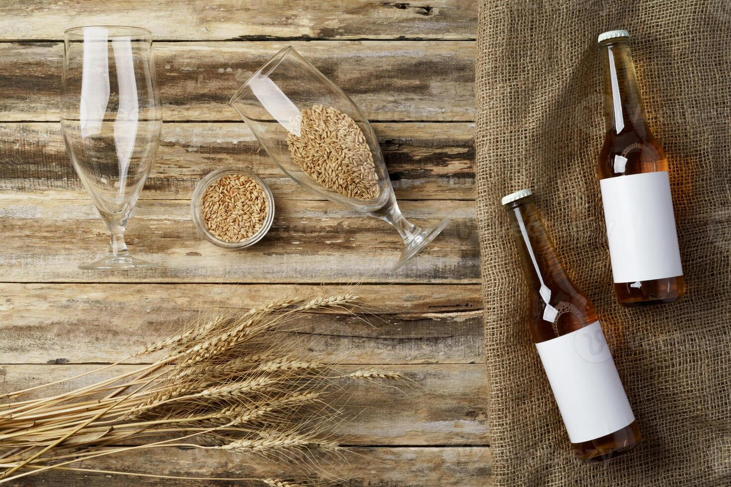 A bottle of beer and grain. Top view. Free space for text. photo