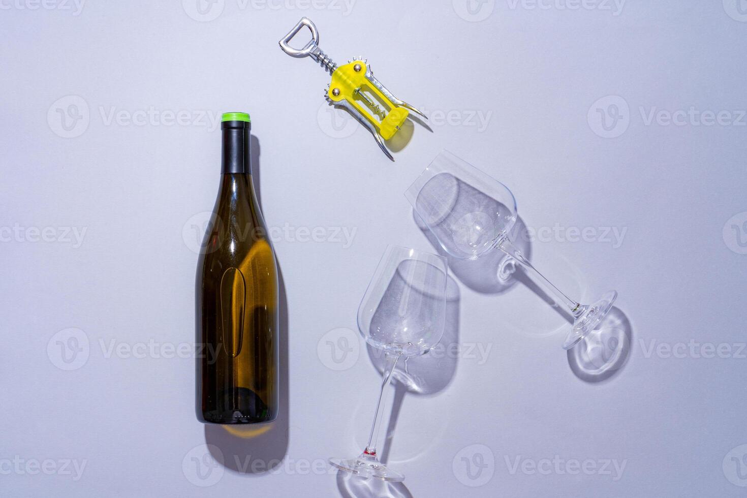 Wine bottle and glass on gray background flat lay photo