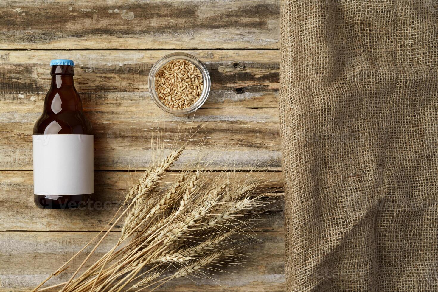A bottle of beer and grain. Top view. Free space for text. photo