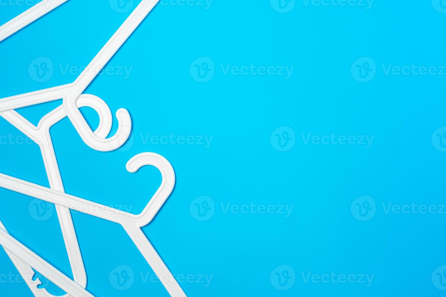 Blue hanger on trendy blue color background. Template fashion blog social media. photo