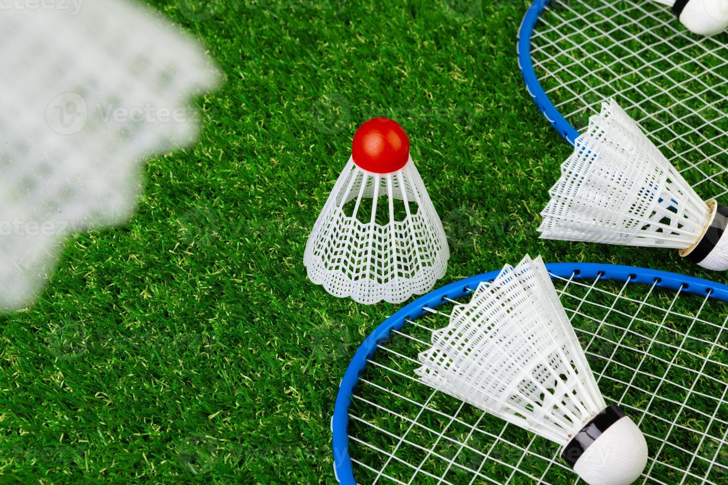 Badminton game rackets and shuttlecock on grass photo