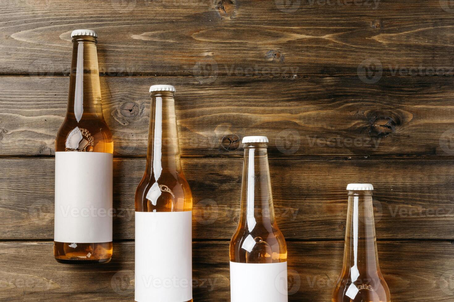 Beer bottle on a brown wooden table flat lay background with a copy space photo