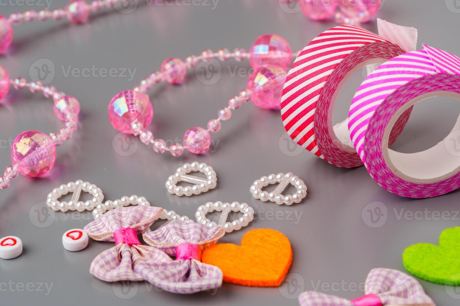 Crafting materials and tools arranged on a gray surface during a creative project photo