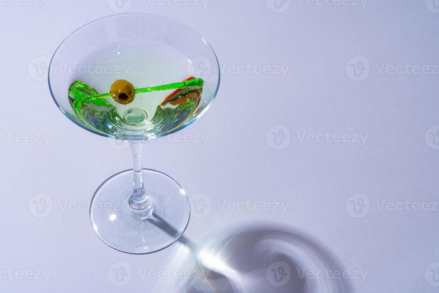 Glass of fresh cocktail on color background photo