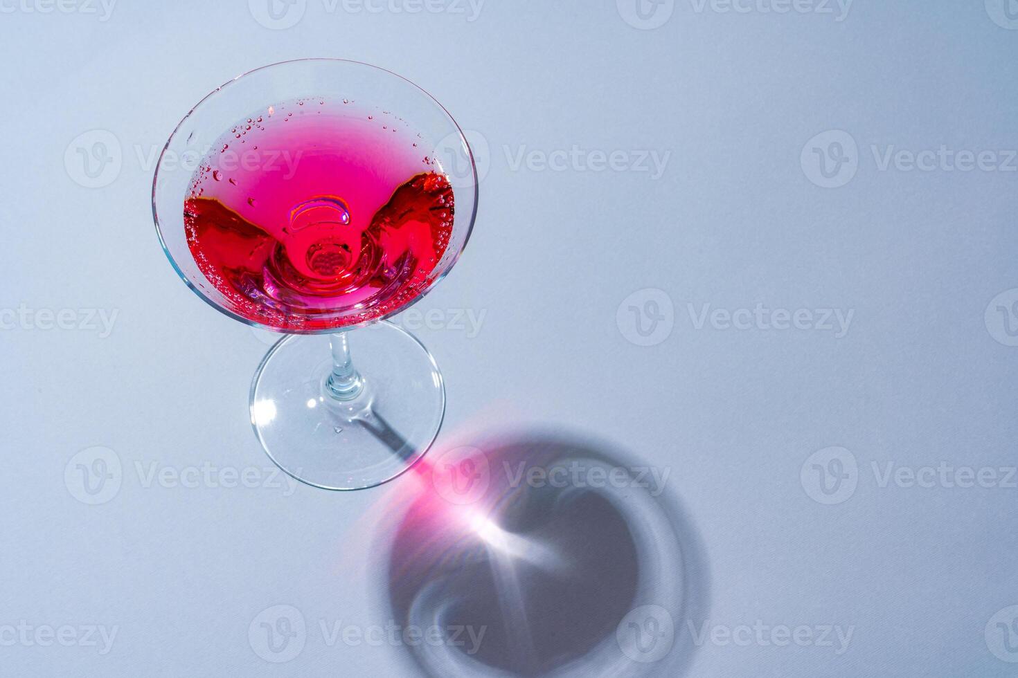Glass of fresh cocktail on color background photo