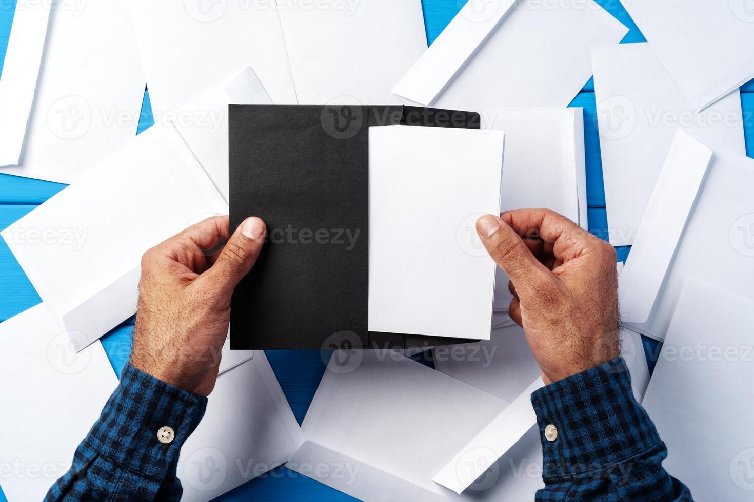 Business correspondence. Top view of man hands holding mockup envelope with letter. Copy space. photo