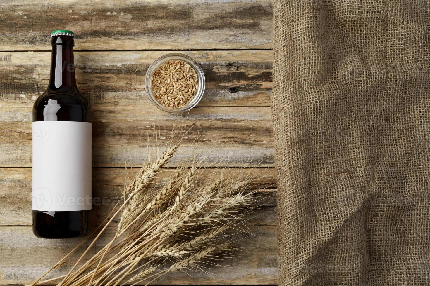 A bottle of beer and grain. Top view. Free space for text. photo