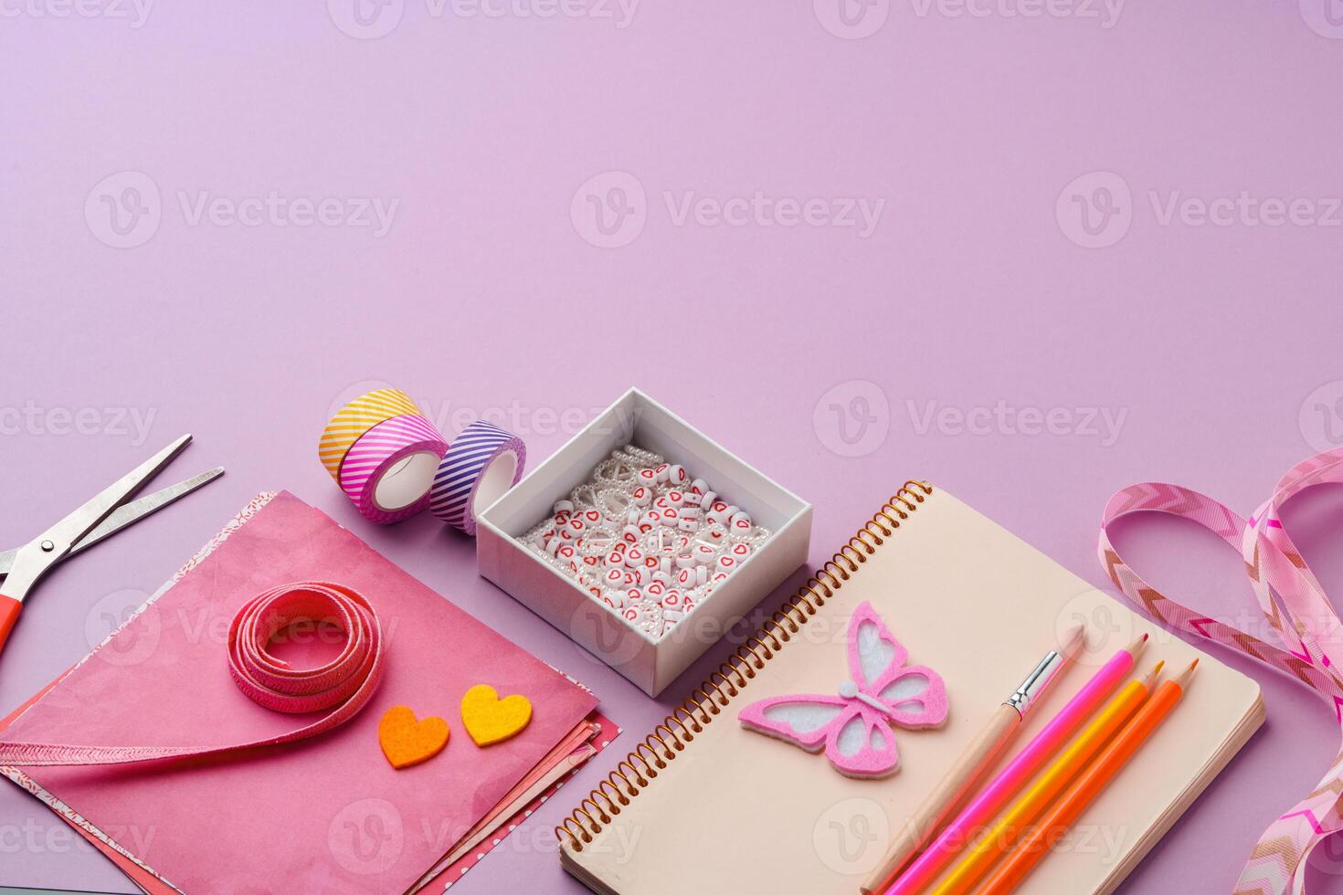 Crafting supplies on a purple background ready for creative projects photo