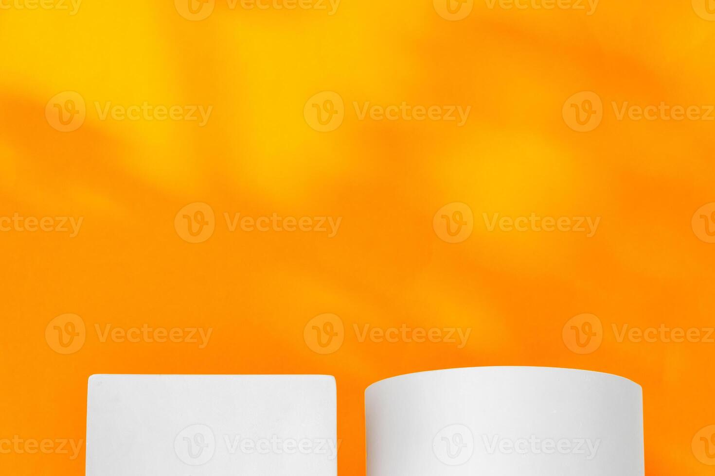 White geometric shapes on a vibrant orange background with soft shadows in a well-lit indoor setting photo