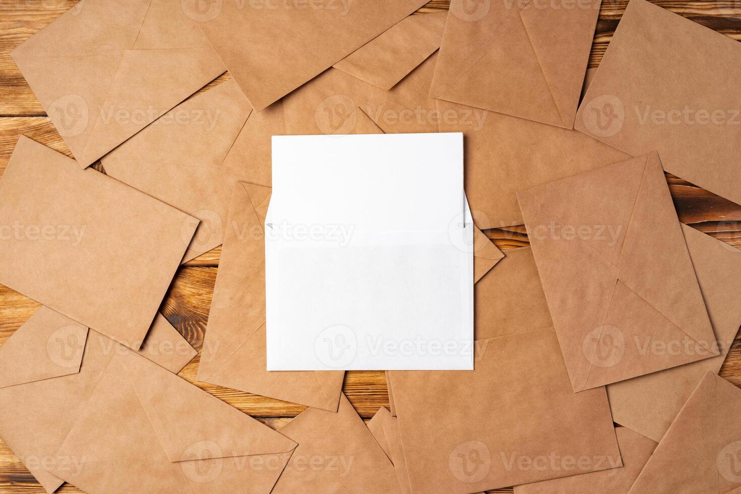 Stack of envelopes on working desk top view. Business mail photo