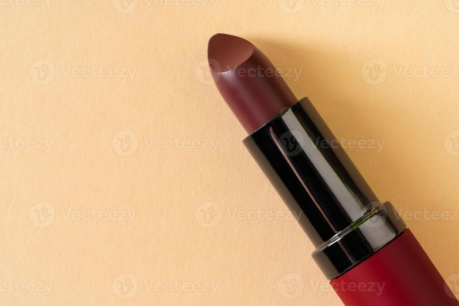 Dark red new lipstick container close up photo