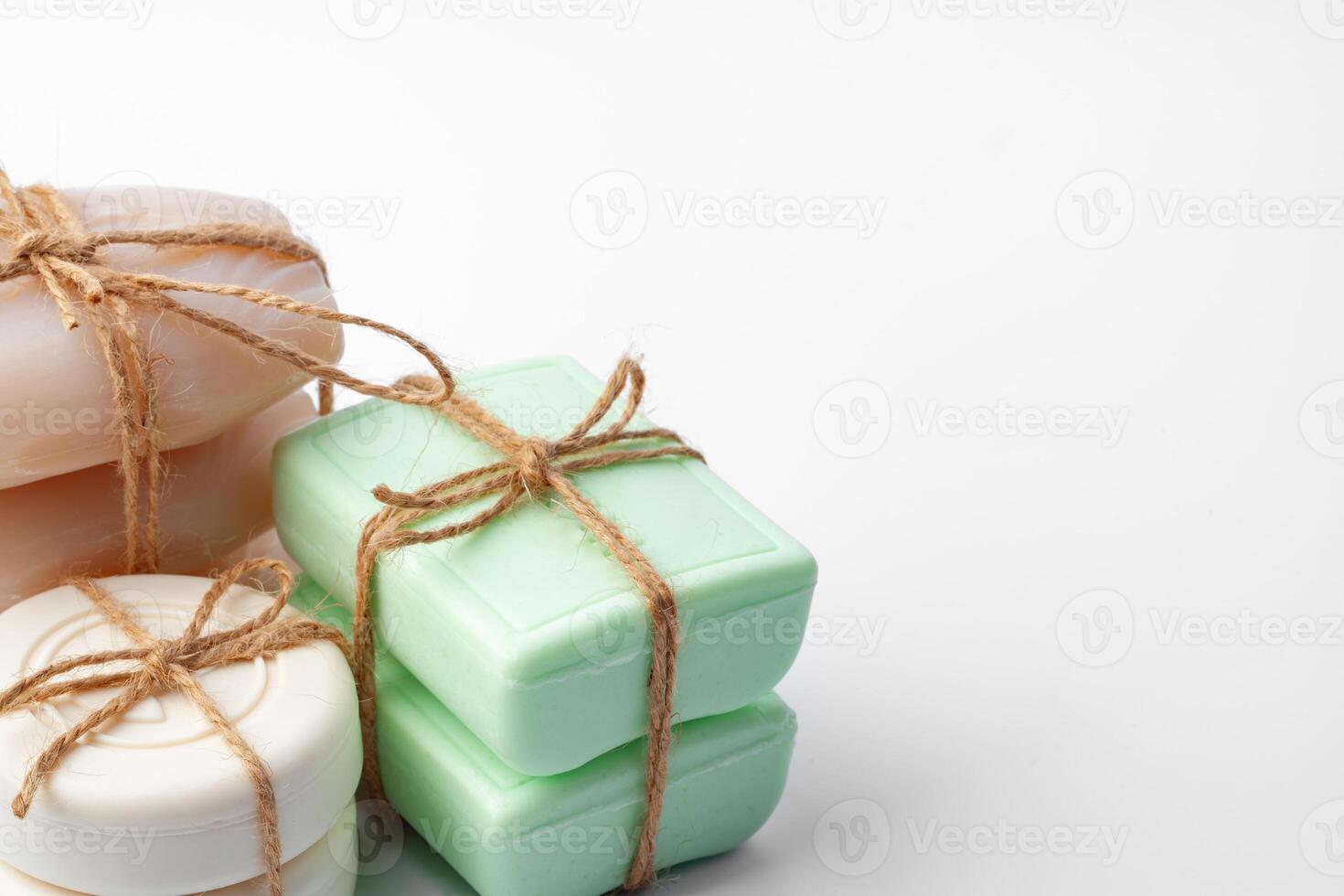 Beige and green soap bars on white background photo
