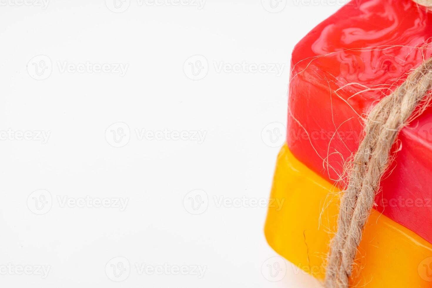Color handmade soap tied with twine on white background photo