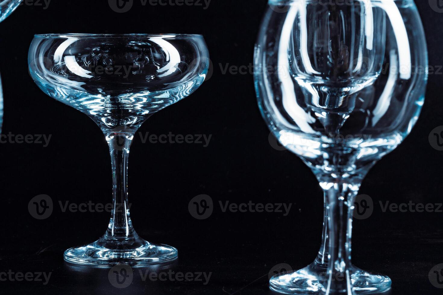 Empty glasses for drinks on dark background photo