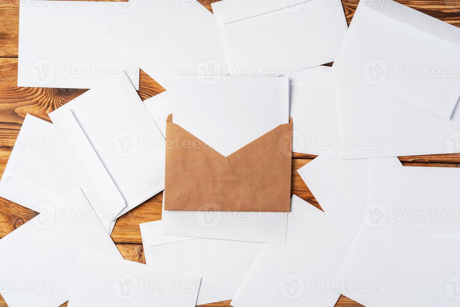Stack of envelopes on working desk top view. Business mail photo