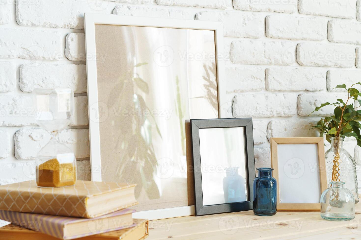 Wooden frame mockup on table with modern vase and books photo