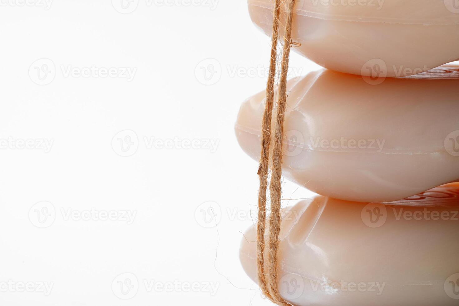 Soap bars tied with twine on white background photo