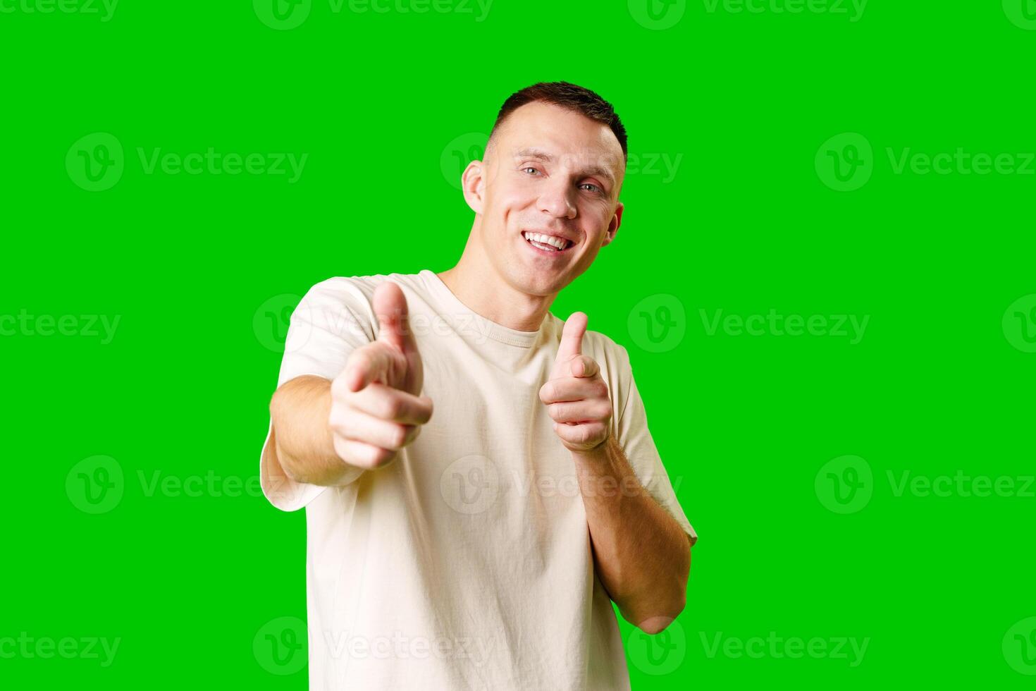 Young Man Posing Playfully in Casual Attire With Green Background photo
