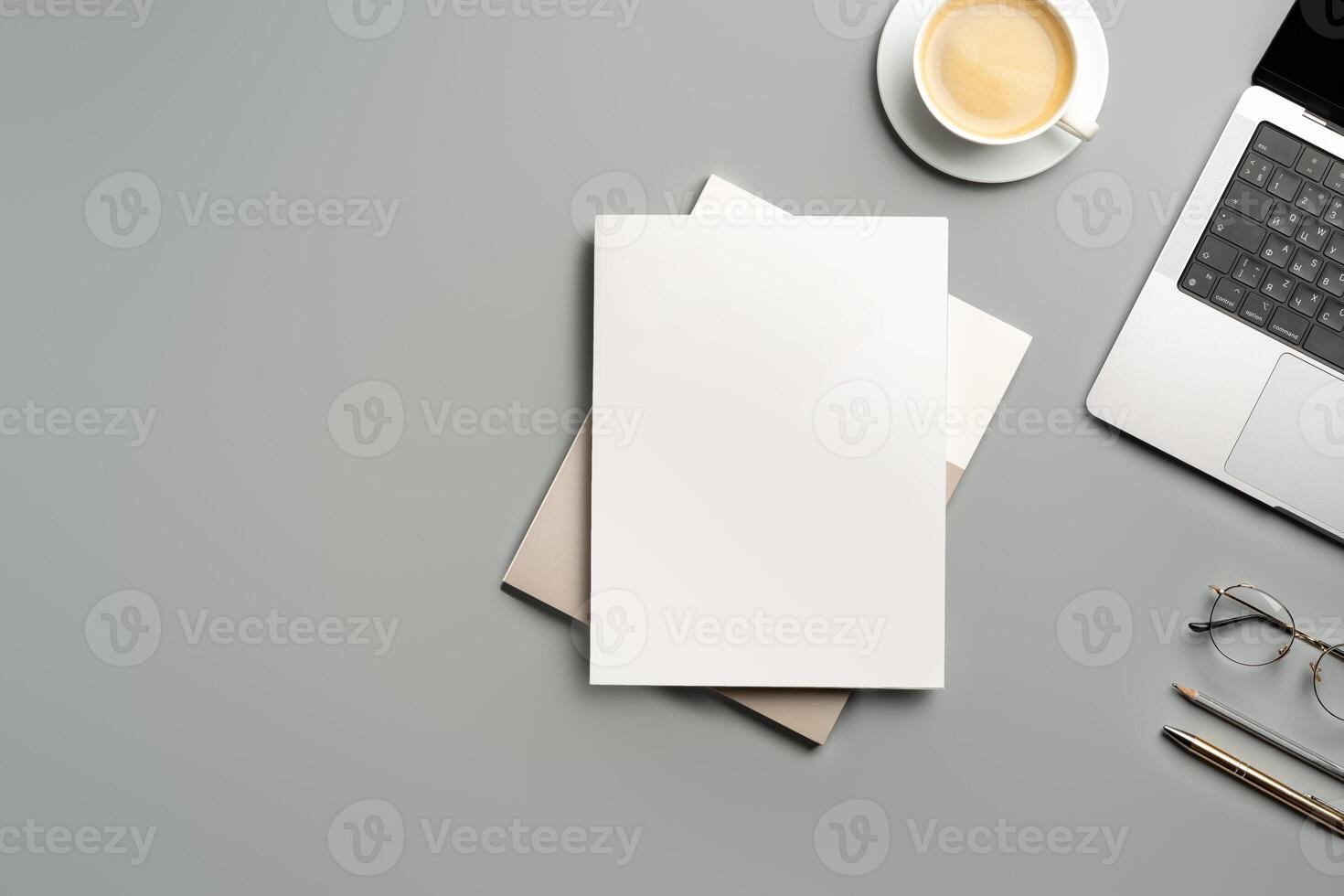Organized Workspace Featuring Laptop and Blank Paper at Desk in Natural Light photo