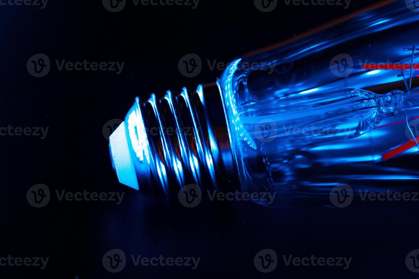 Light bulb on black background close up photo