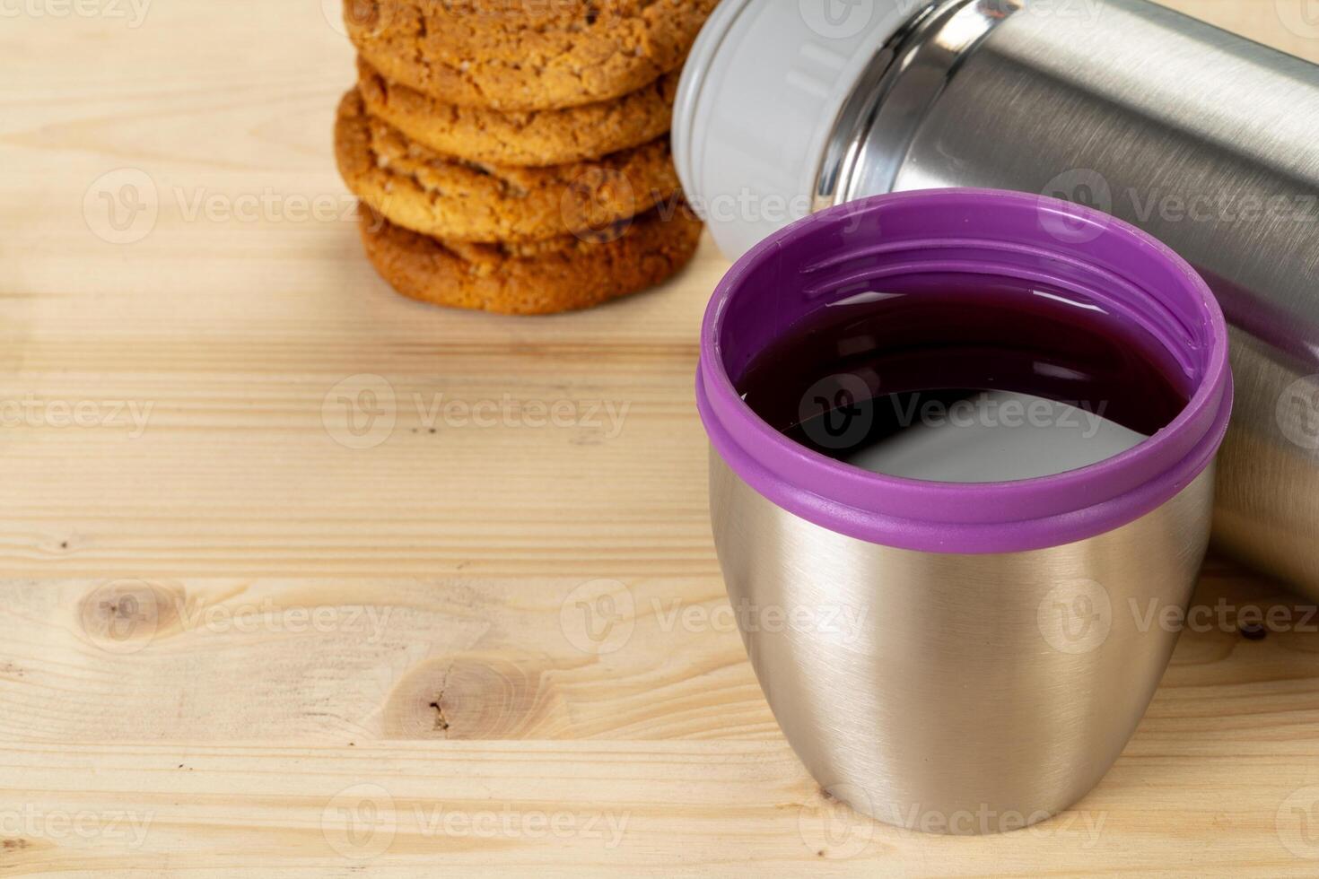 Aluminum metal thermos container bottle close up on table photo