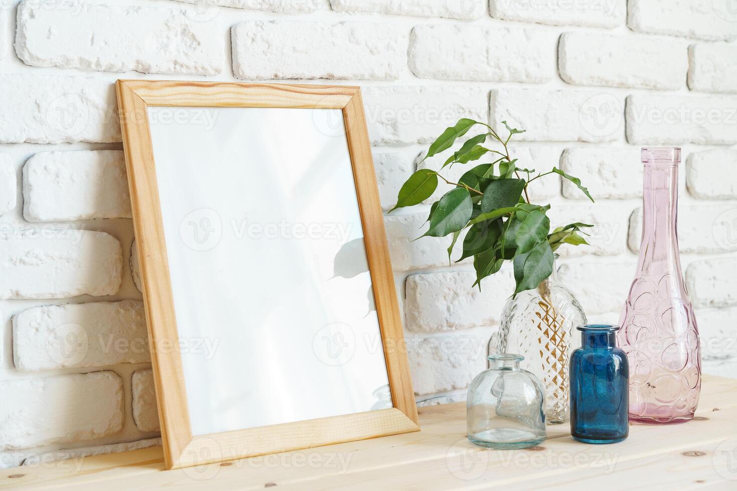 Mockup with a frame and dry flowers in a vase on a white table photo