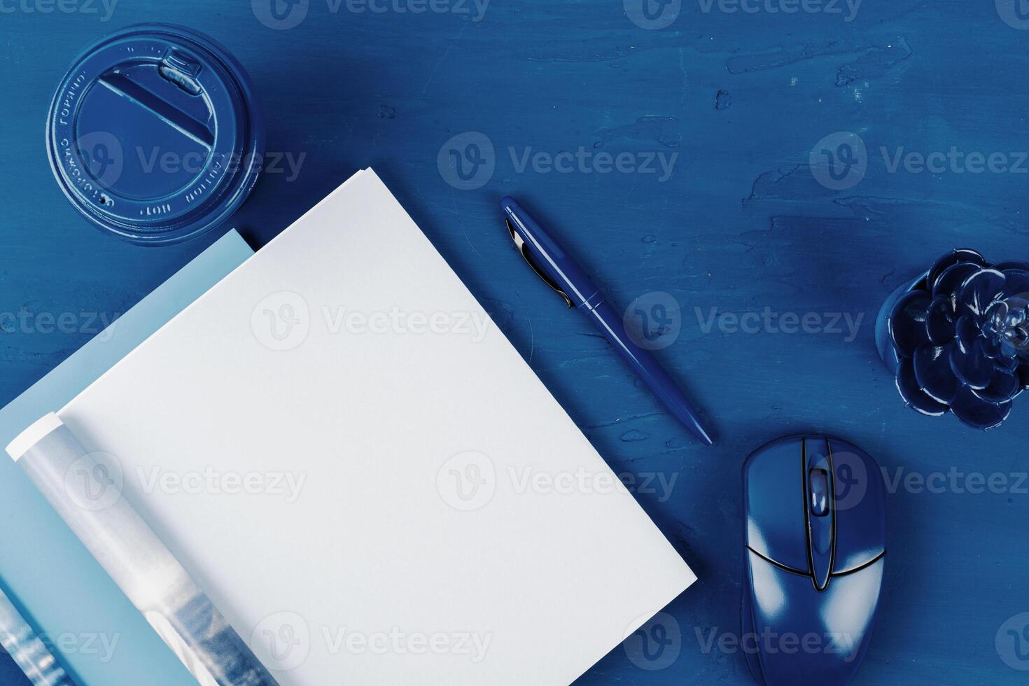 Top view of open magazine page with copy space on classic blue background photo