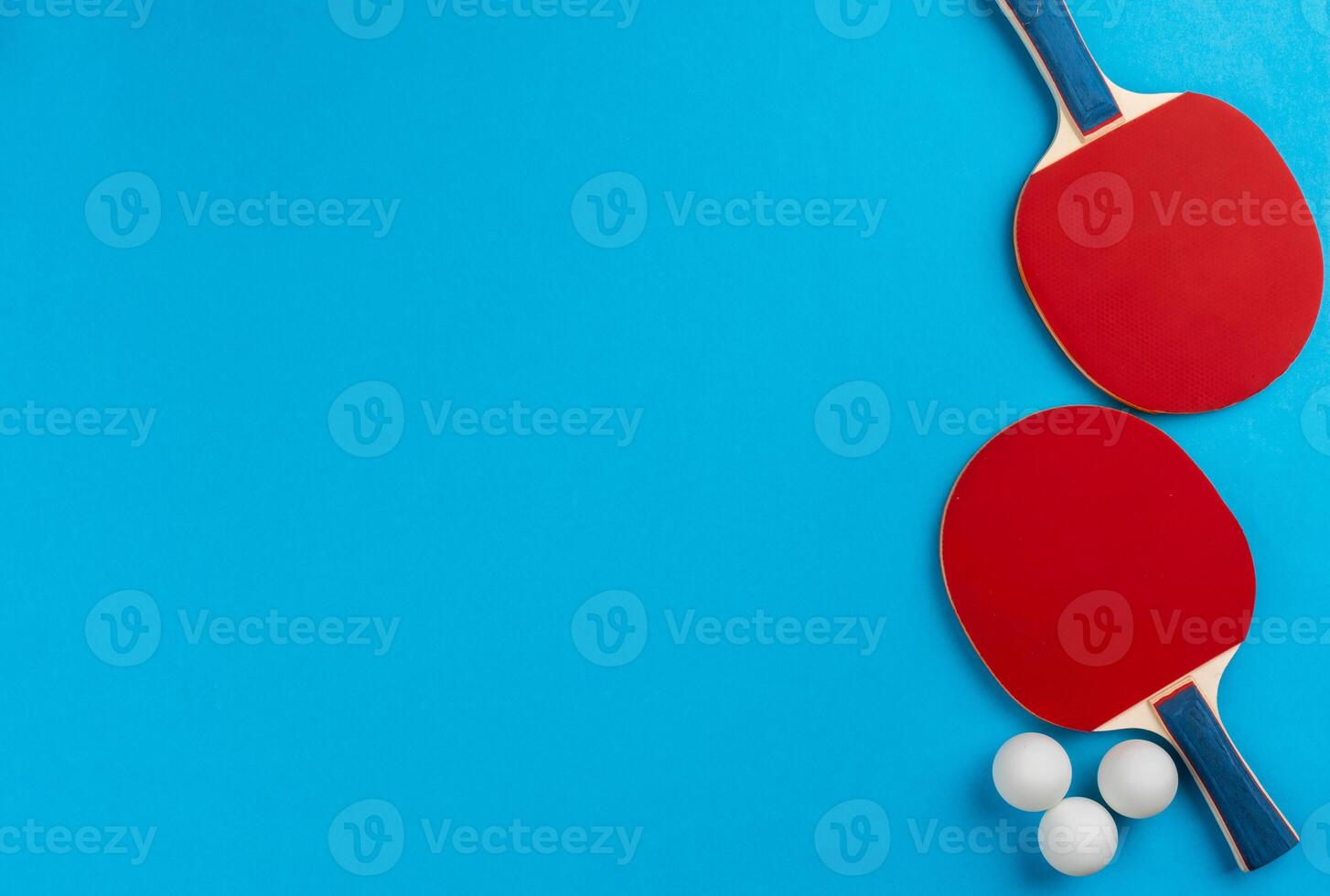 Ping pong racket and ball on blue background photo