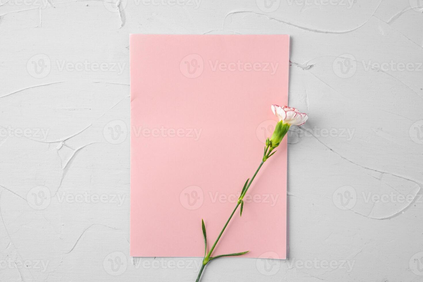 Top view of a pink paper letter and flowers with copy space photo