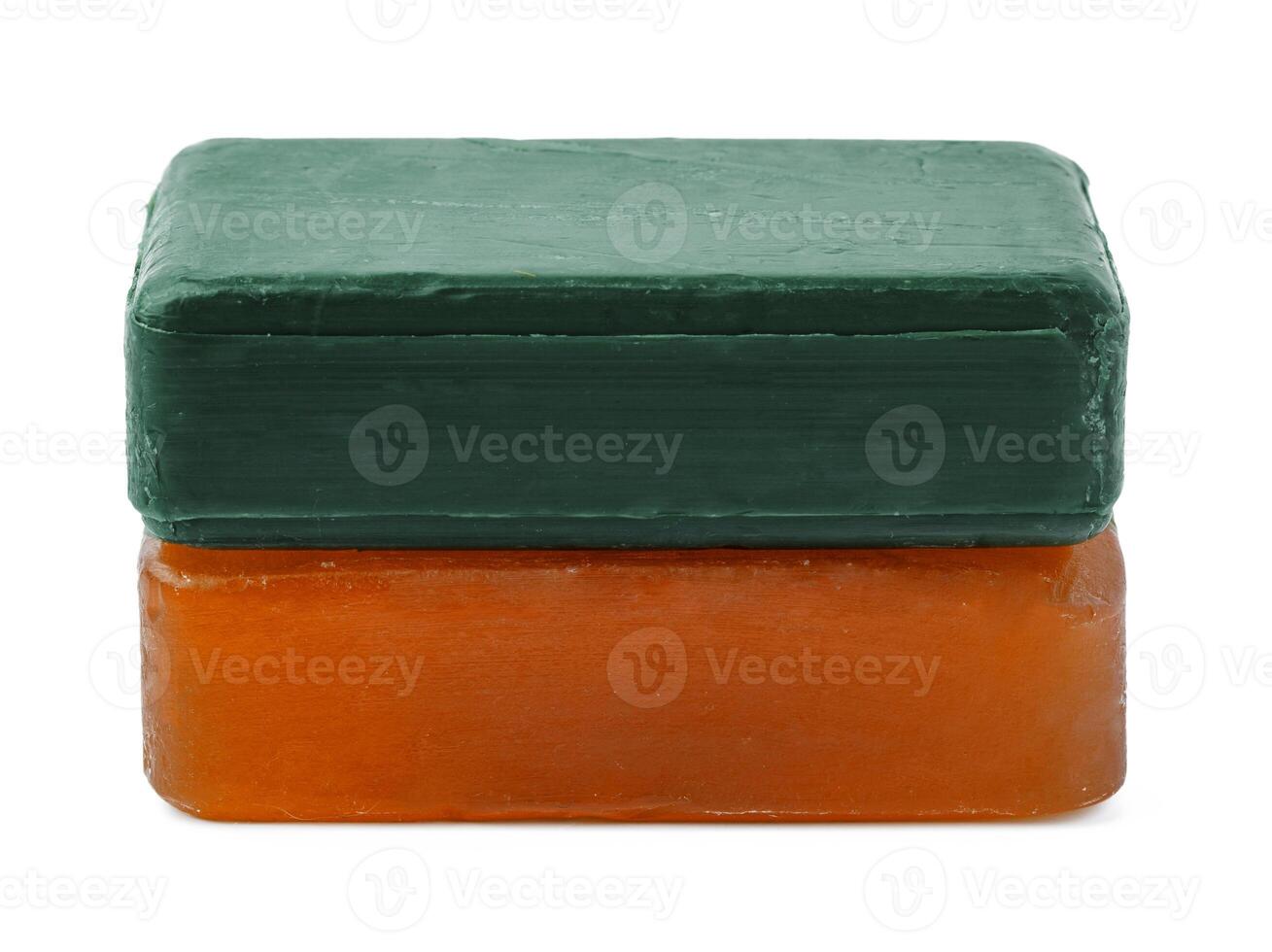 Beige and green soap bars on white background photo