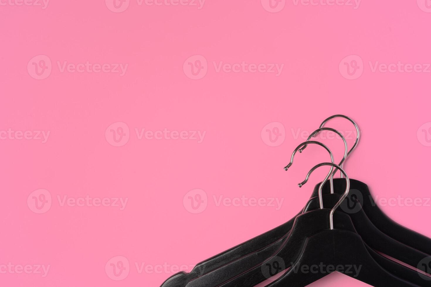 Flat lay composition with empty hangers on pink background photo