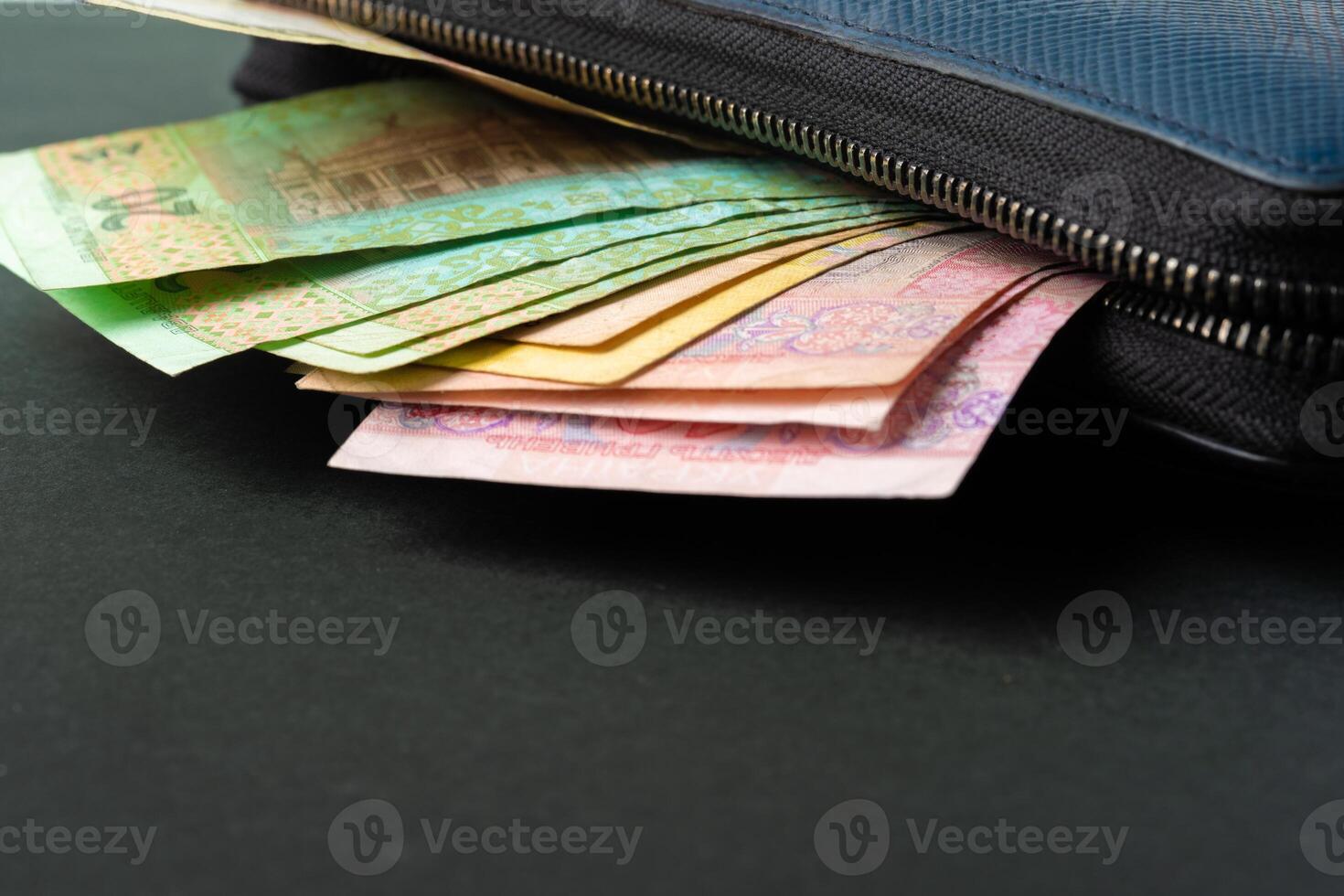 Blue wallet full of money Ukrainian Hryvnia photo