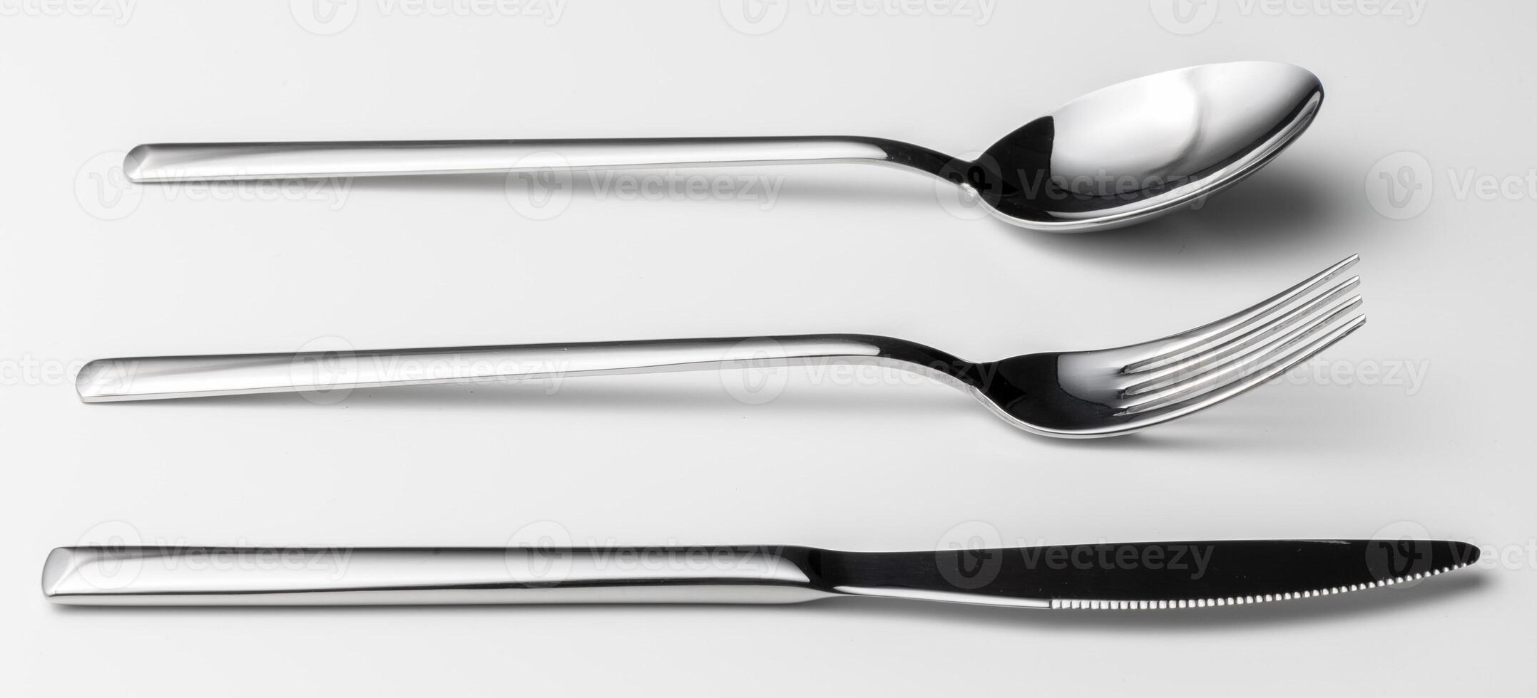 Spoon, fork and knife on a white background photo