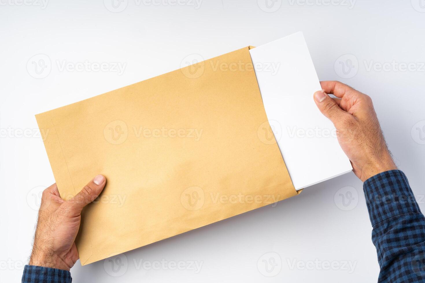 Top view of male hands hold , open an envelope above white background photo