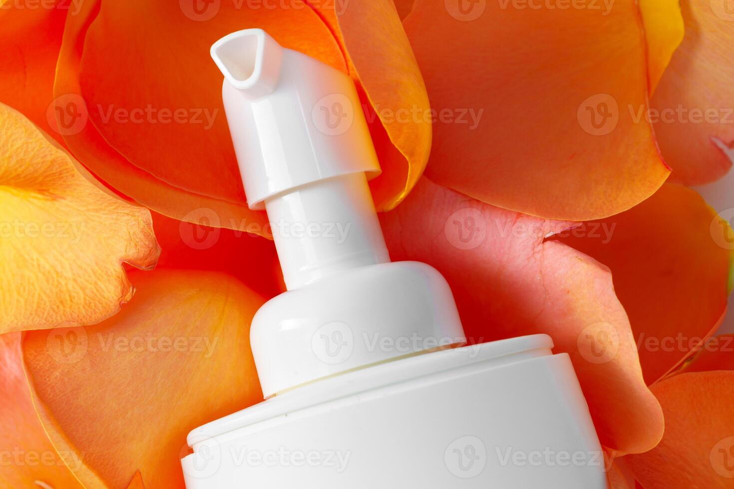 Cosmetics containers decorated with orange rose petals photo