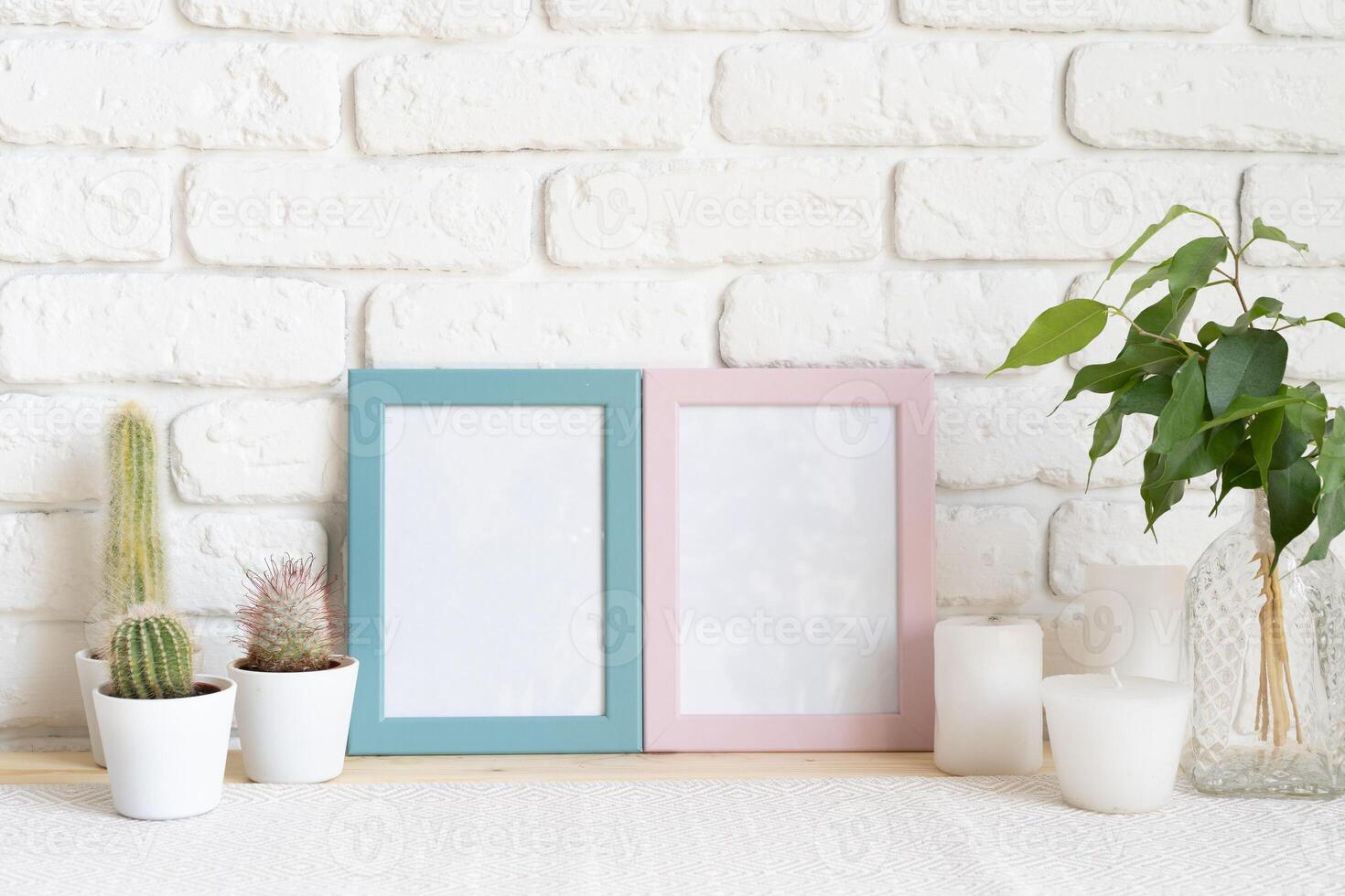 Square wooden photo frame and cactus plants on the table