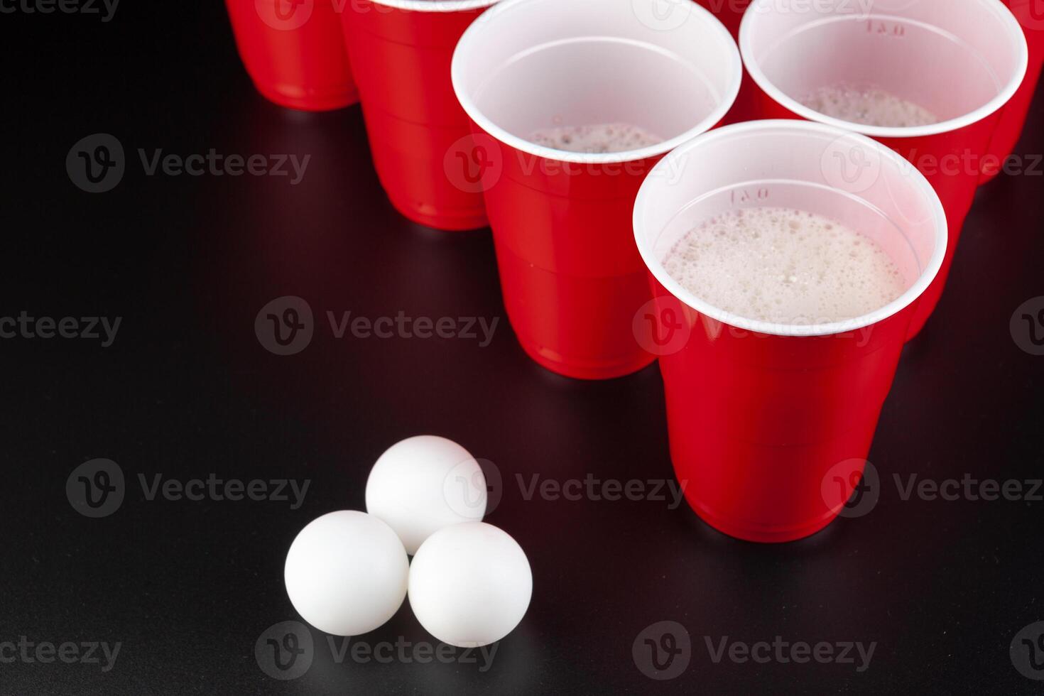 The arrangement of red plastic cups for game of beer pong photo