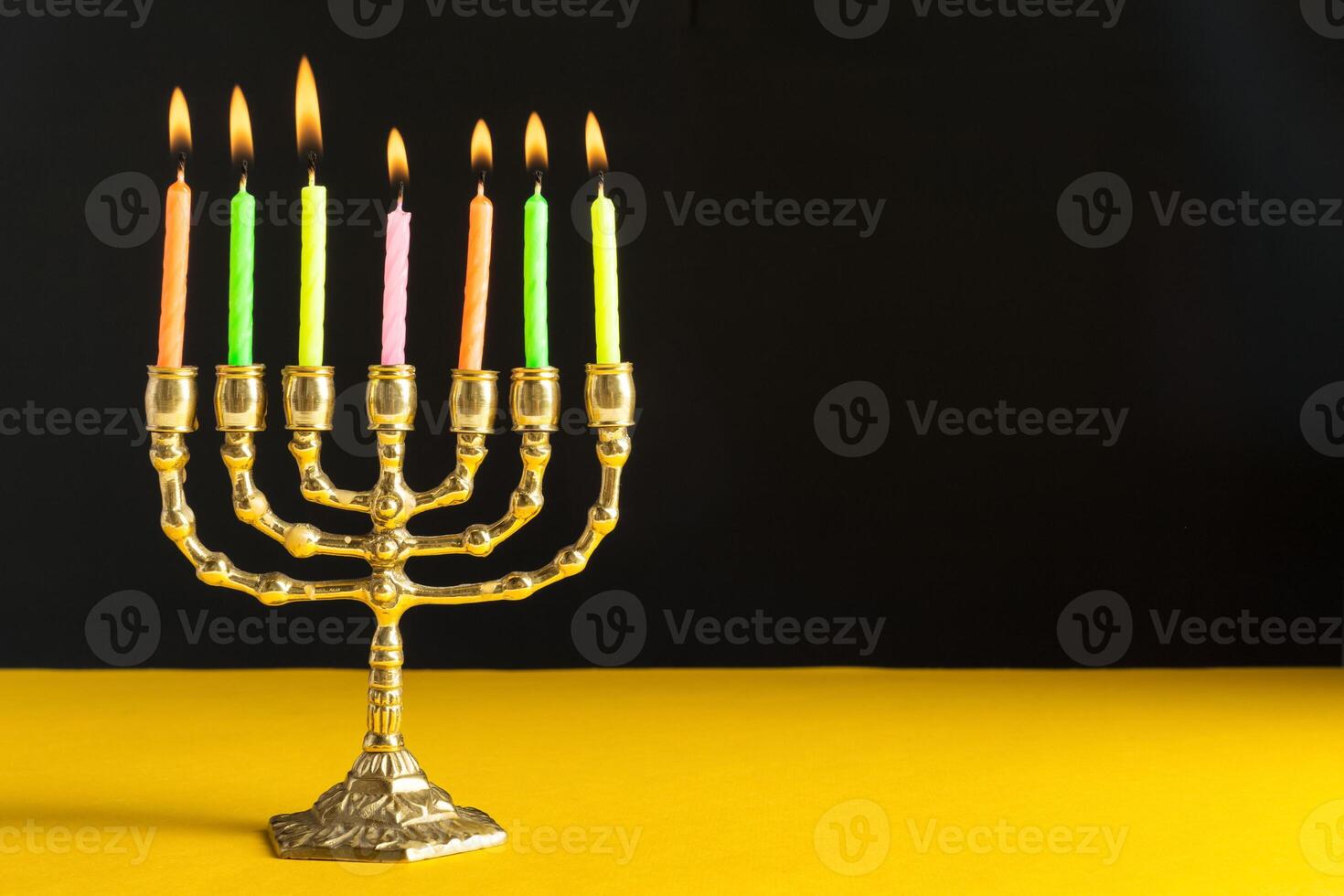 Bronze Hanukkah menorah with burning candles photo