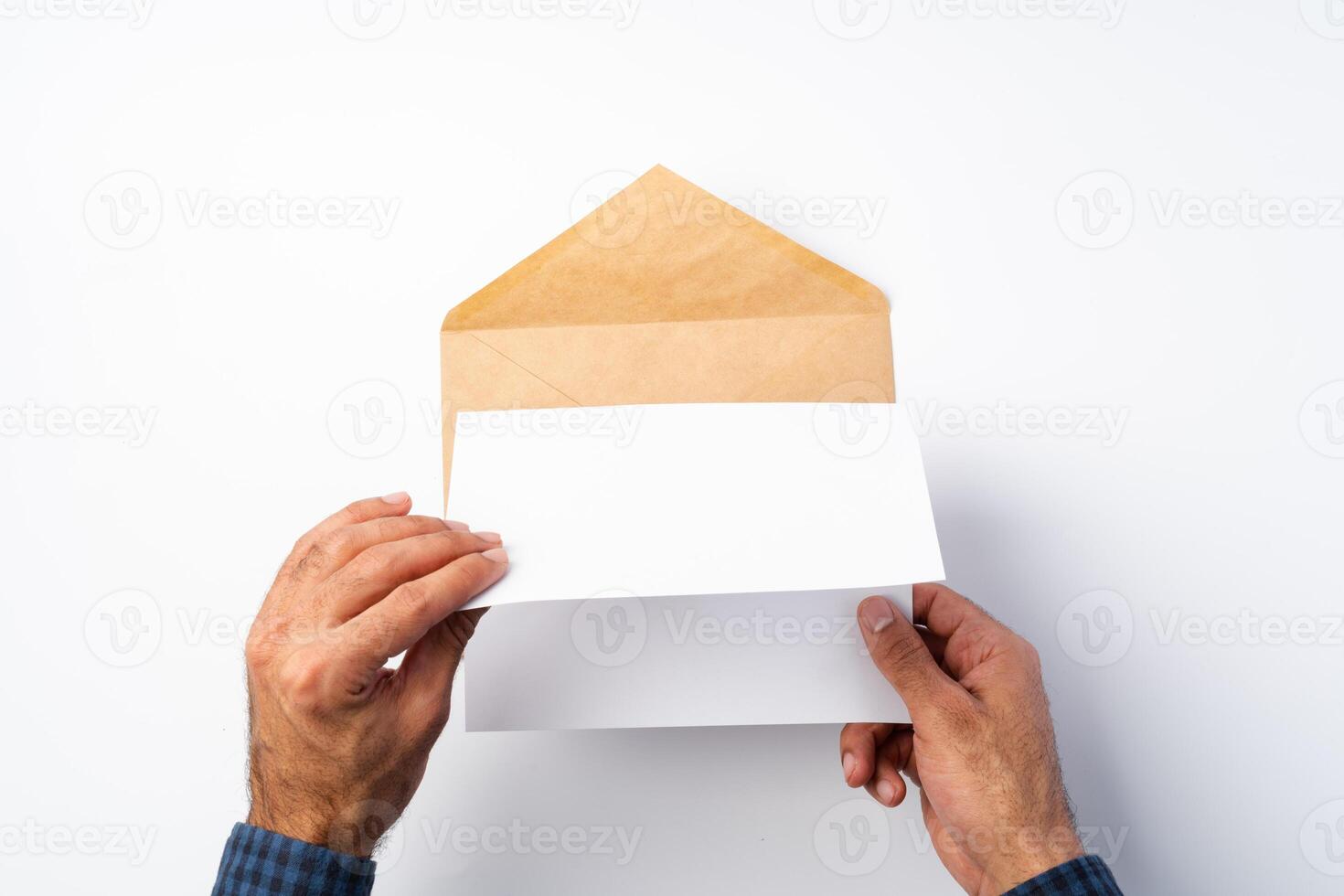 Top view of male hands hold , open an envelope above white background photo