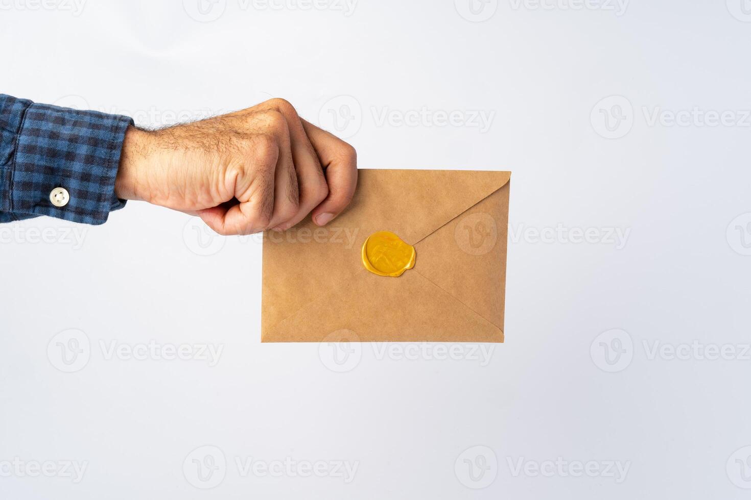 Male hands holding an envelope with a wax seal photo