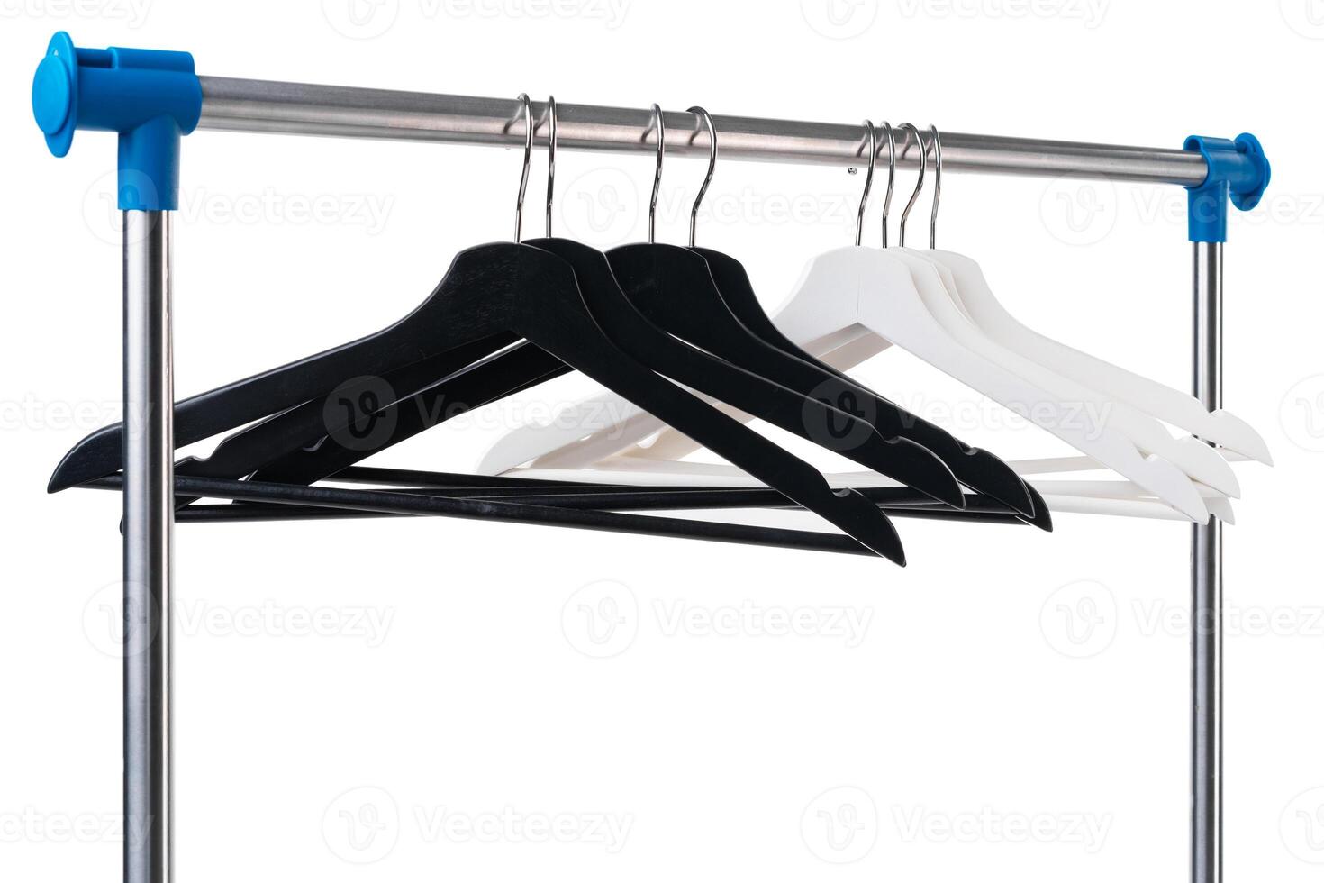 Metal rack with clothes hangers on white background photo