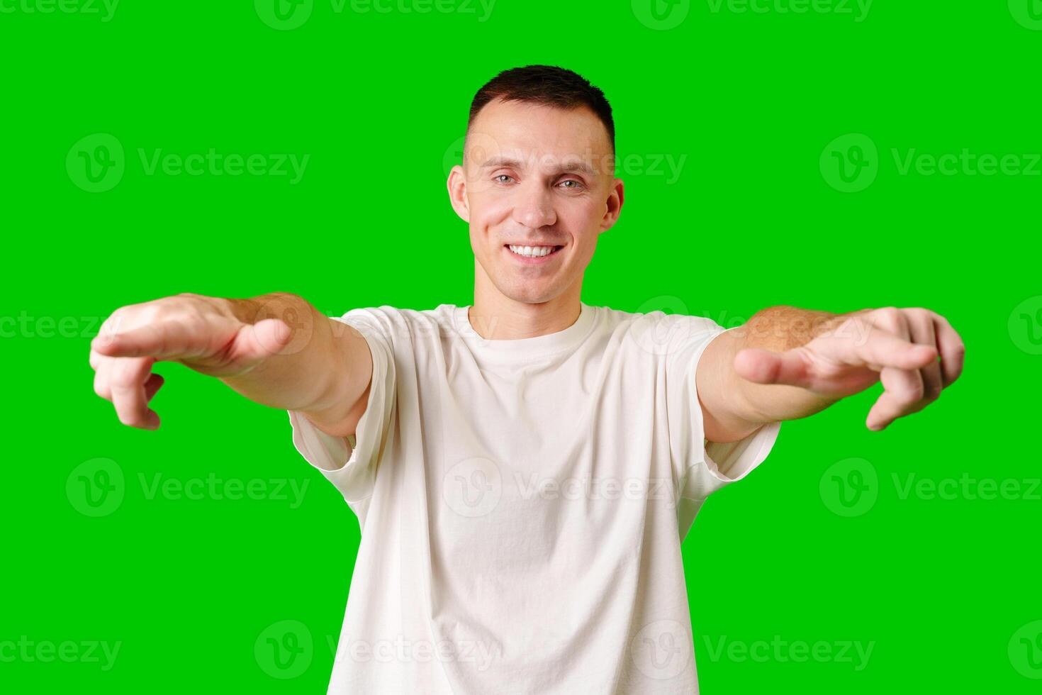 Young Man Posing Playfully in Casual Attire With Green Background photo