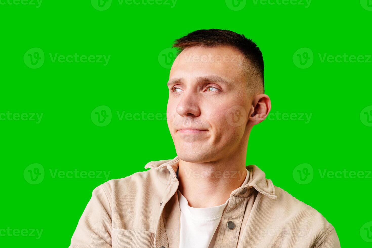 Young Man Wearing Casual Jacket Against Vibrant Green Background During Bright Indoor Setting photo
