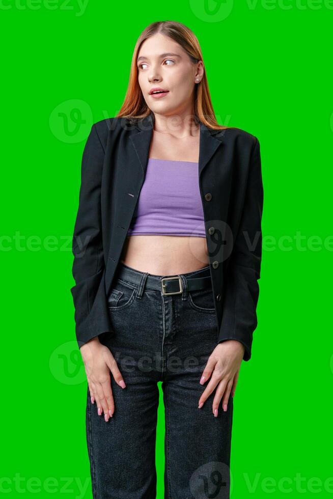 Young Woman With Surprised Expression in Front of Green Screen photo