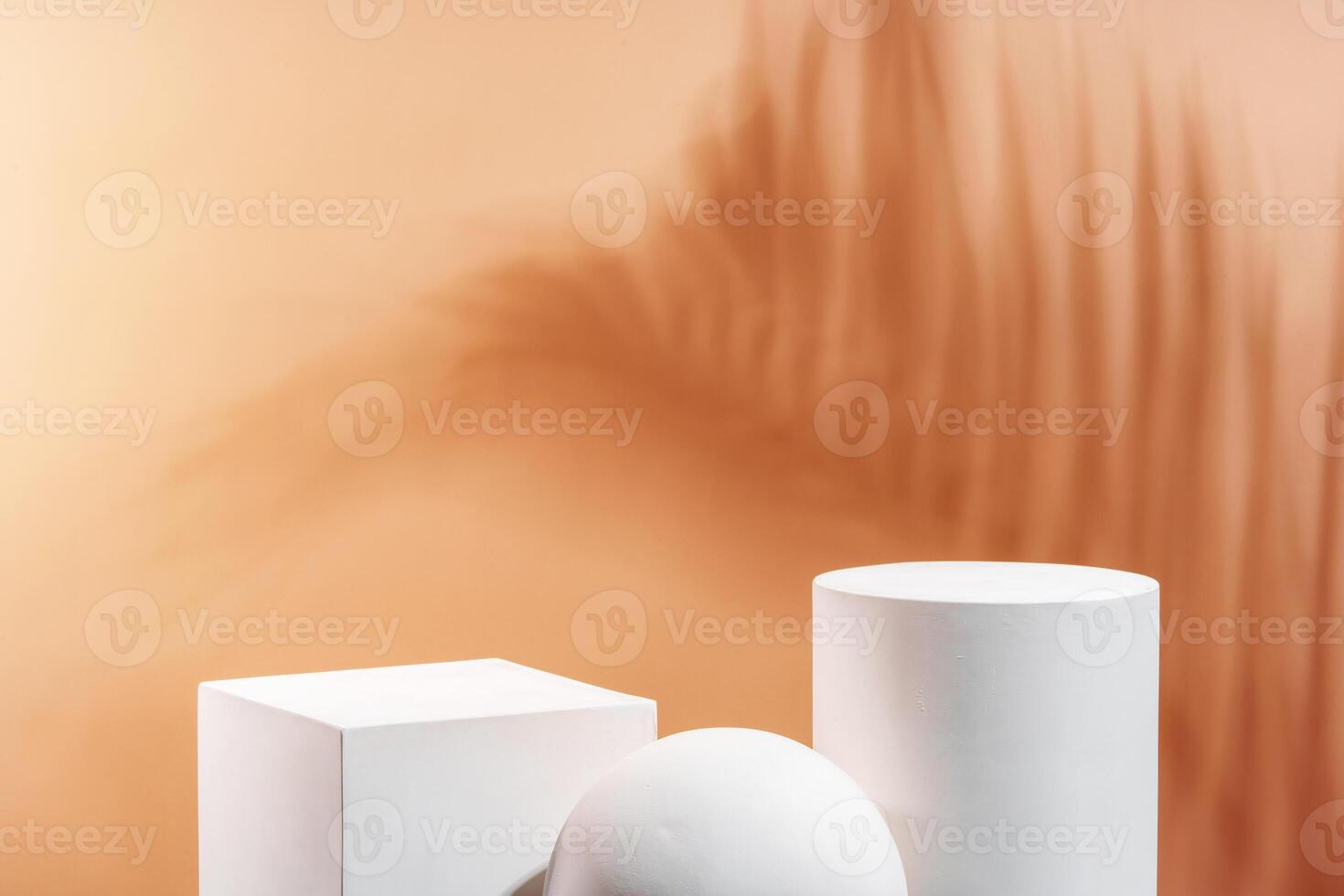 White geometric shapes arranged stylishly on a soft peach background in a minimalist setting photo