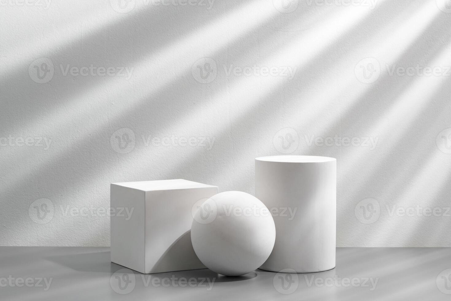 Abstract composition featuring three white geometric shapes in a minimalist interior setting photo